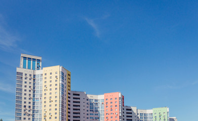 Fototapeta premium high rise residential building and bright color sky with copy space