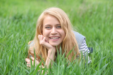 Young beautiful woman on green grass