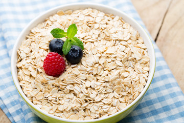 Oatmeal porridge with berries. Raspberries and blueberries.