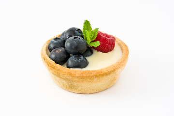 Delicious tartlet with raspberries and blueberries isolated on white background
