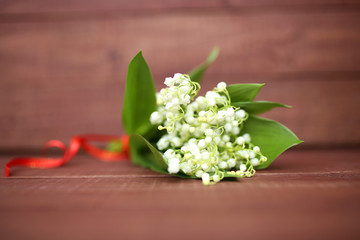 Lily of the valley on wooden background. Lily of the valley bouquet.  Lily of the valley with copy space.