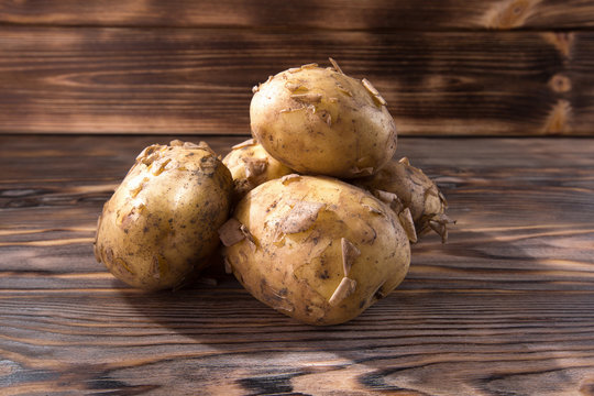 young potatoes on the wooden background