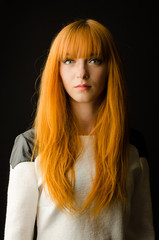 Beautiful young happy woman with long flowing red hair     