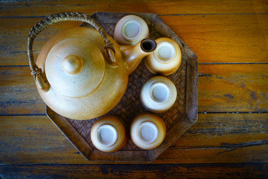 Ceramic teapot and cups for the tea ceremony on wooden table