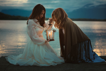 Women looking into warm light lantern