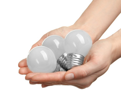 Woman hands holding bulbs, isolated on white