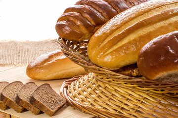 Arrangement of bread in basket  on wooden table