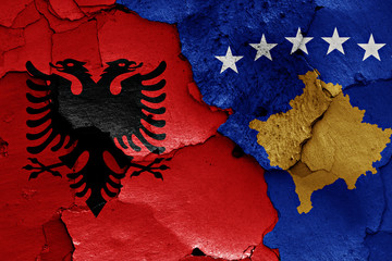 flags of Albania and Kosovo painted on cracked wall