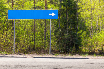 Blue road sign near highway with blank place