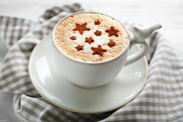 Cup of fresh coffee on napkin