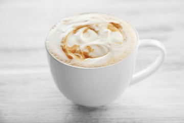 Cup of fresh coffee on wooden background