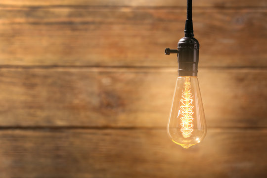 Bright bulb on wooden background