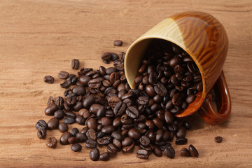 coffee beans and cup on wood
