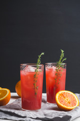 Cocktail made of Sicilian orange on the rustic wooden background