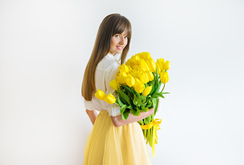 young happy woman with yellow tulips