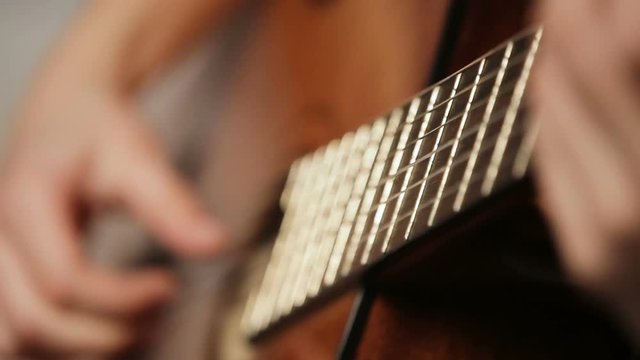 Female hand playing on acoustic guitar. Close-up.Female hands on the strings of a guitar.