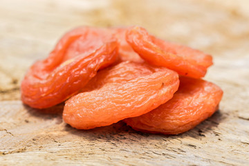 Dried apricots on wooden surface