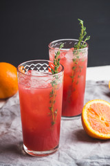 Cocktail made of Sicilian orange on the rustic wooden background. Shallow depth of field.