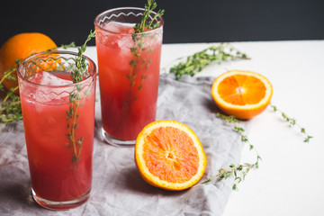 Cocktail made of Sicilian orange on the rustic wooden background. Shallow depth of field.