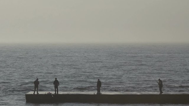 Fisherman on the dock during the spring sunrise