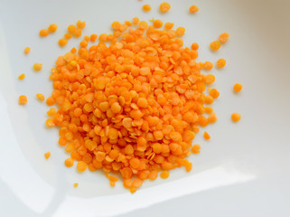 knot red lentils on a white background