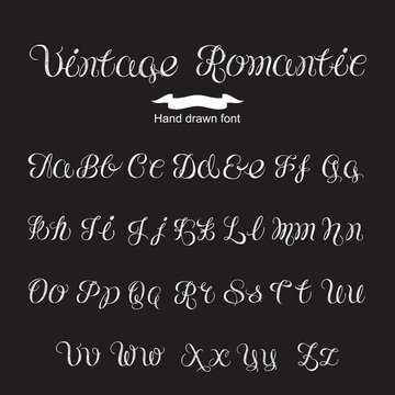 Hand written calligraphy vintage romantic font. White letters 