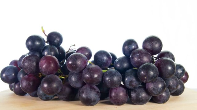 black grapes rotates, white background, 4k stop motion