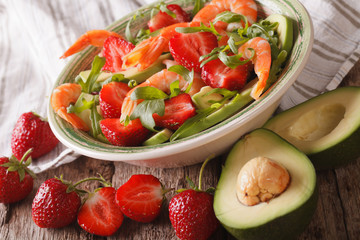 Seafood salad with strawberries and avocado close-up. horizontal
