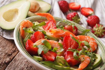 salad with strawberries, avocado, shrimp and arugula close-up. horizontal
