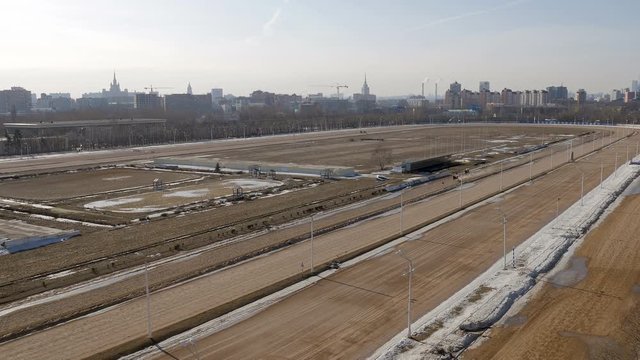 panorama of winter open stadium, Stalin skyscrapers are on background