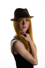 Fototapeta na wymiar beautiful red-haired girl with a hat in the studio 