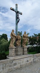 Obraz premium The crucifixion of Jesus and the sculptures on the bridge in Pisek.