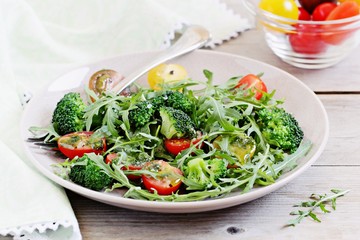 Broccoli salad with tomatoes and arugula .Selective focus 