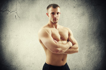 Bare-chested strong guy with crossed arms