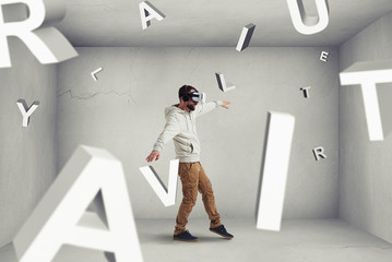 Man in virtual reality glasses stepping between flying letters