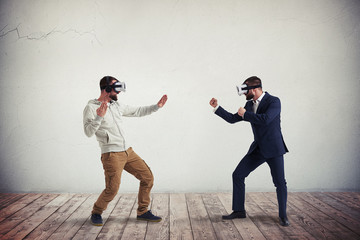 Two men combating in virtual reality glasses