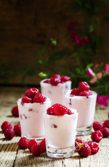 Yoghurt with fresh raspberry, vintage wooden background, selecti