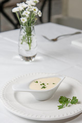 Tasty Bechamel sauce or white sauce with fresh greenery