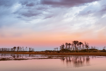 Dramatic Sky Along Coastal Inlet at Sunset