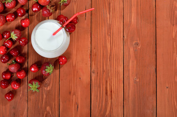 Fototapeta na wymiar Milk deser with berries on wooden background.