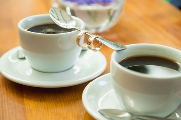 Wedding rings on a spoon for cava