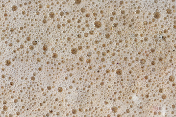 Close up of sea foam over sand