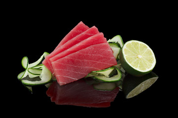 Tuna sashimi over black background - obrazy, fototapety, plakaty