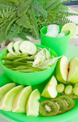 Obraz na płótnie Canvas Green Fruits and Vegetables – Assorted green fruits and vegetables with green plates and bowls.