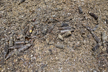 Glass waste in recycling facility. Brown bottles