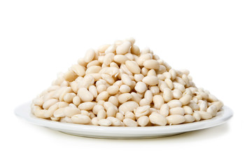 Hill of Beans – Navy beans piled high on a white plate. White background.