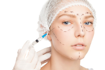 Surgeon injecting woman's face with outlines