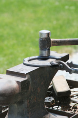 Shaping a Horseshoe – A farrier blacksmith shapes and pounds a horseshoe on an anvil so it will...