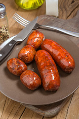 several Iberian sausages grilled in  dish