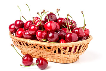 cherries in a wicker basket isolated on white background